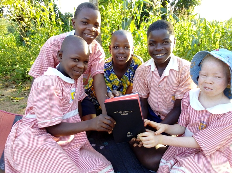 Children holding a bible
